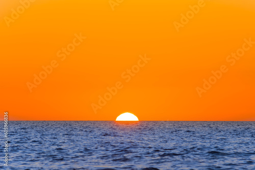 Fototapeta Naklejka Na Ścianę i Meble -  red sunset over the calm sea, natural marine background