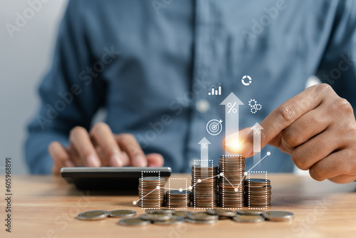 Businessman stacking money coins accounting for increase financial interest rate and business investment growth from dividend, Business Finance and Money, Save money for prepare in the future... photo
