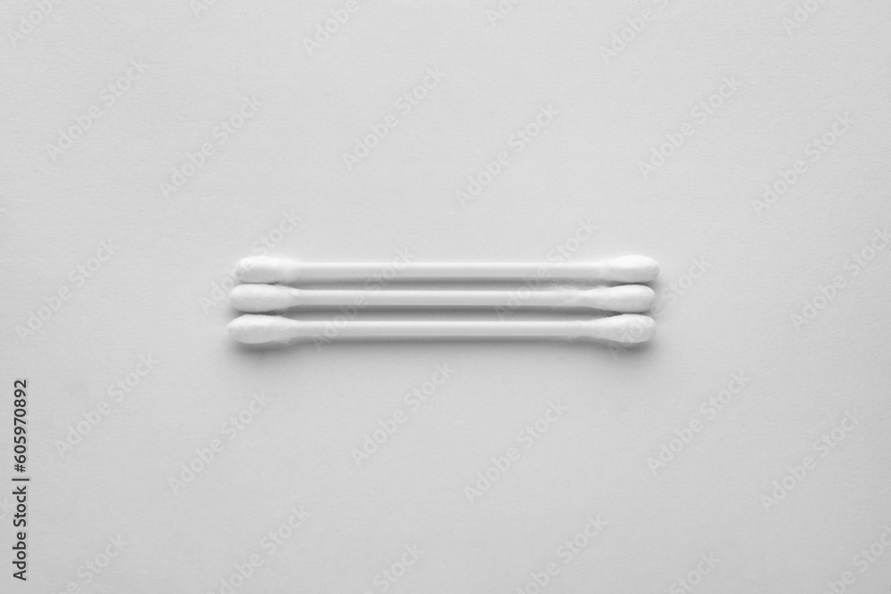 Clean cotton buds on white background, top view. Hygienic accessory Clean cotton buds on white background, top view. Hygienic accessory