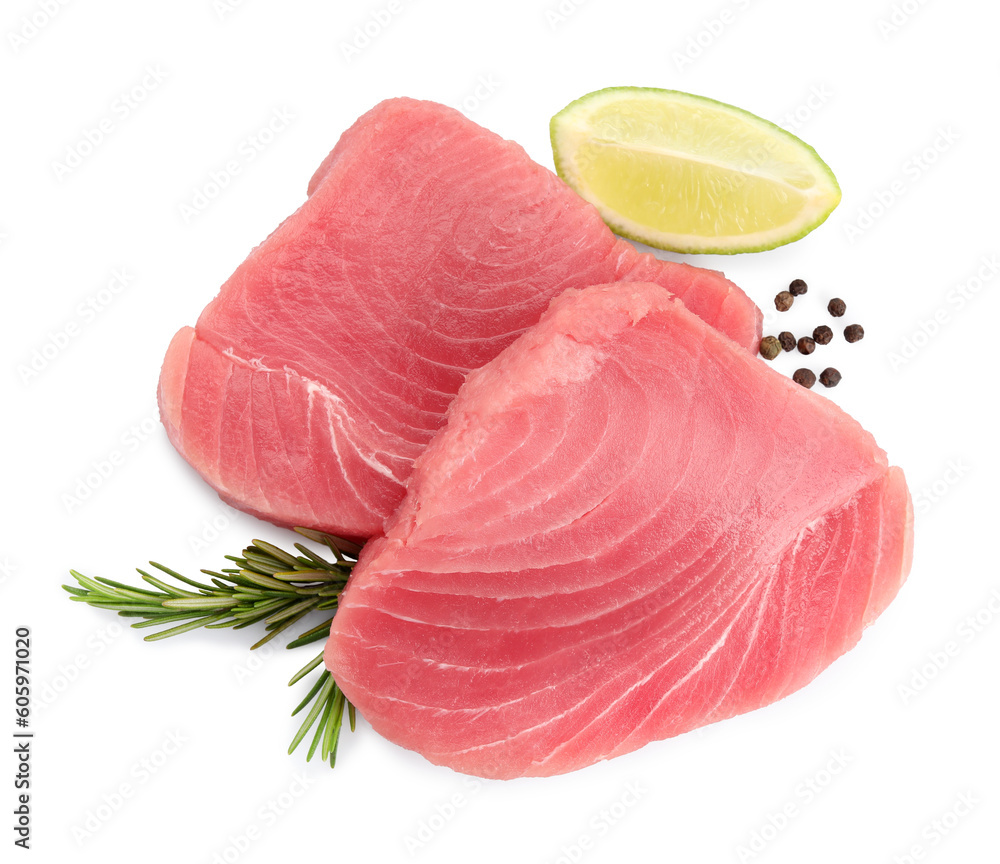 Fresh raw tuna fillets with peppercorns and lime wedge on white background, top view Fresh raw tuna fillets with peppercorns and lime wedge on white background, top view