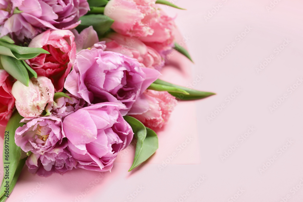 Beautiful bouquet of colorful tulip flowers on pink background