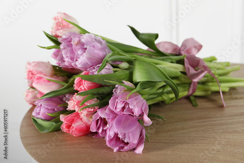 Beautiful bouquet of colorful tulip flowers on wooden table © New Africa