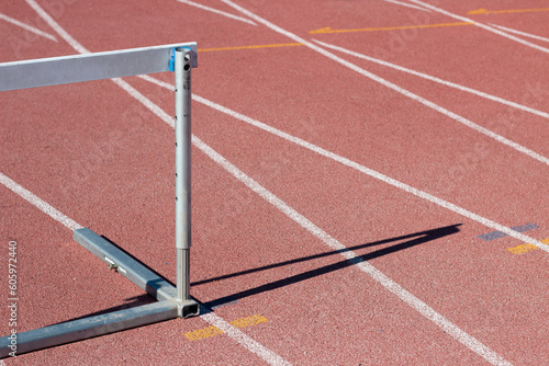 Straight white lines on an athletics tartan. jumping fence