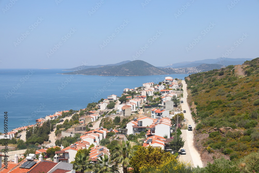 View of the highway, houses and mountains on the Aegean coast of Turkey, orange groves. Türkiye, May 2023.