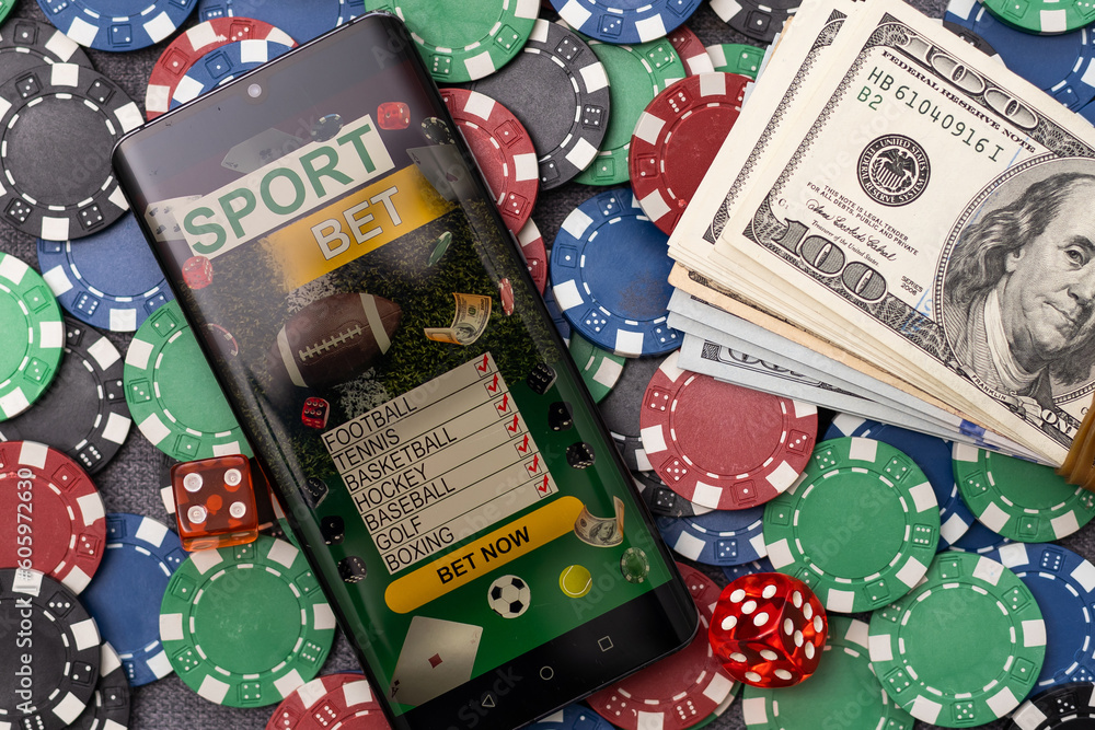 Online poker concept. Smartphone and poker chips on a green background. Poker online banner. Copy space. Vignette. Place for text. Gambling. Background. Online poker concept. Smartphone and poker chips on a green background. Poker online banner. Copy space. Vignette. Place for text. Gambling. Background.