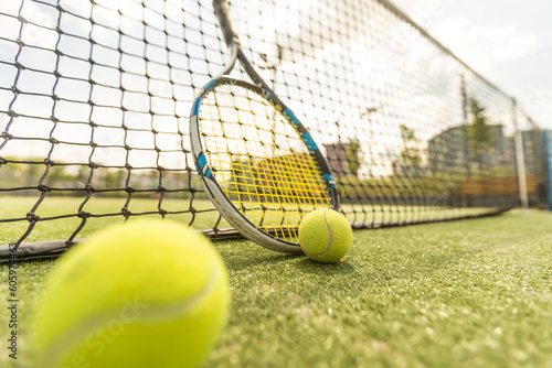 tennis racket with a tennis ball on a tennis court © Angelov