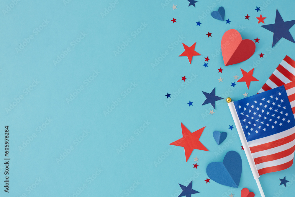 Memorial Day celebration concept. Top view flat lay of American flag, red blue hearts and stars confetti on light blue background with empty space for text or promotional
