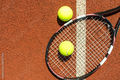 tennis racket with a tennis ball on a tennis court © Angelov