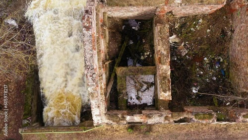Old traditional water mill ruins by the river Nigra in Blome parish. Aerial top down photo
