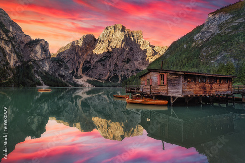 Fototapete Colorful sunrise scene of beautiful Pragser Wildsee with wooden boats, reflectio