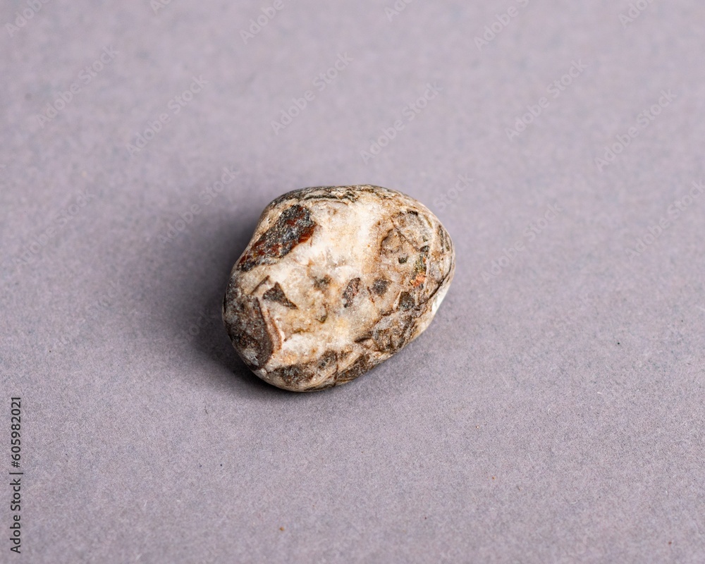 Closeup of holistic stone isolated in gray background Closeup of holistic stone isolated in gray background