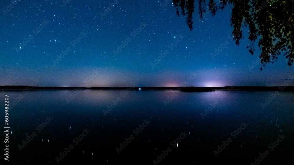Beautiful view of the starry sky reflected on the water's surface. Beautiful view of the starry sky reflected on the water's surface.