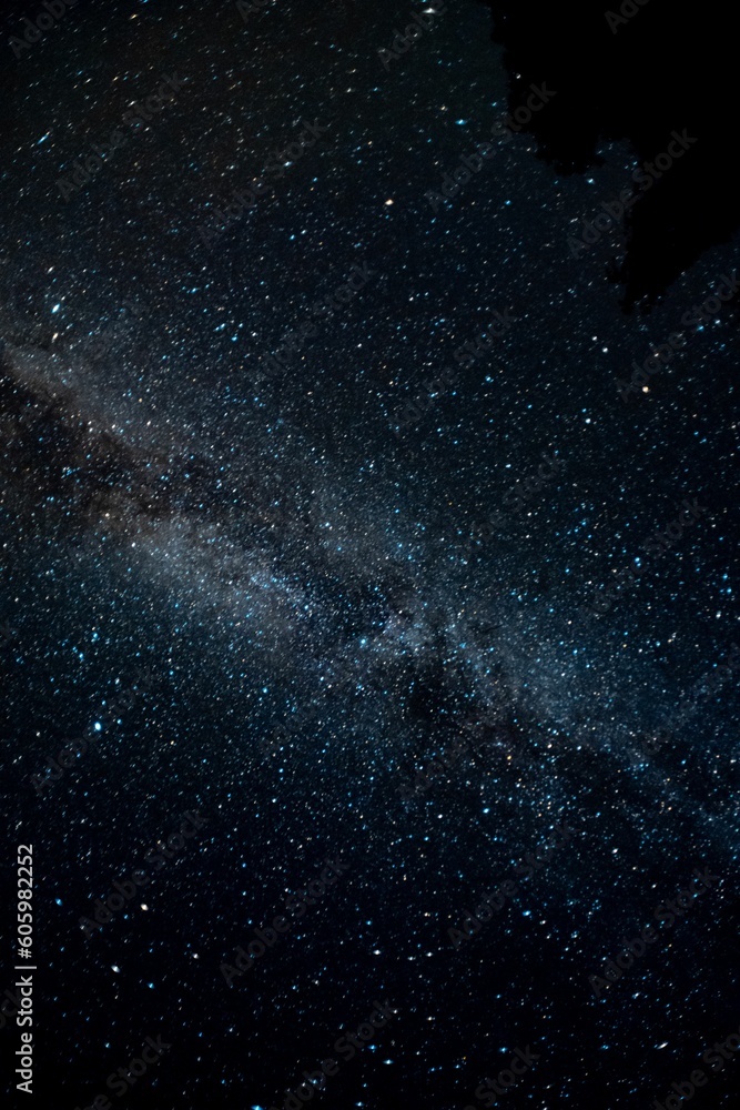 Vertical shot of Milky Way illuminating a dark night sky