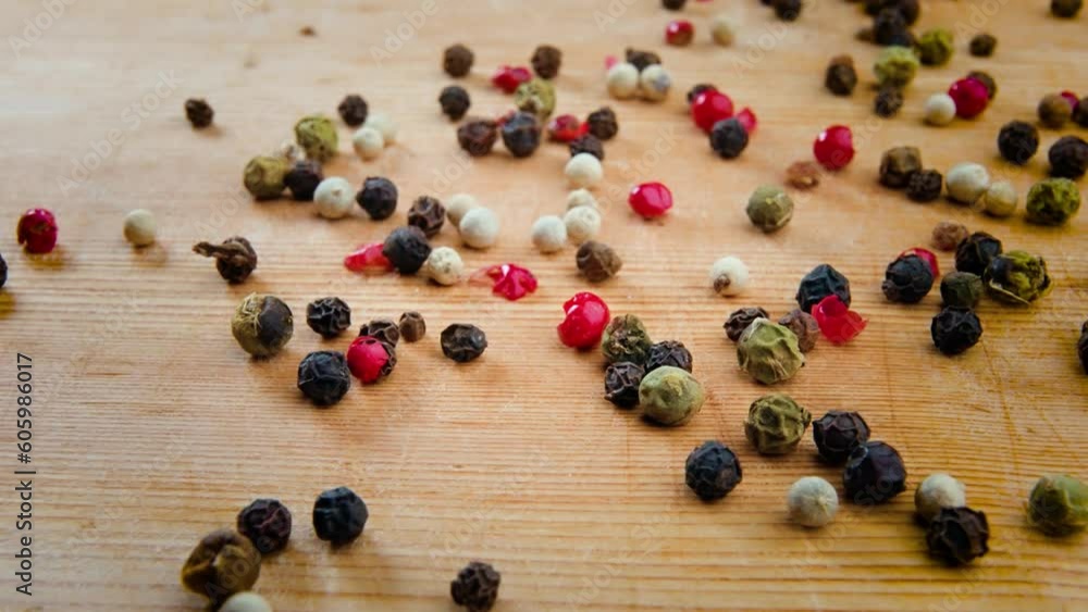 Closeup video of handful of peppercorns blend on a wooden background Closeup video of handful of peppercorns blend on a wooden background