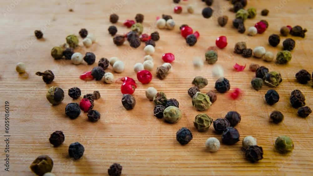 Closeup video of handful of peppercorns blend on a wooden background Closeup video of handful of peppercorns blend on a wooden background