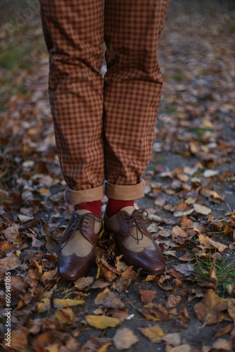 Man standing in an autumn park in beautiful shoes, vintage style 