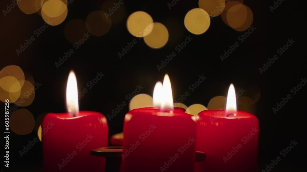 Close-up view of burning candles with a background of Christmas bokeh lights Close-up view of burning candles with a background of Christmas bokeh lights