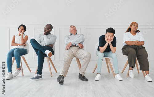 Bored, job interview and diversity with business people in waiting room for tired, frustrated or fatigue. Hiring, hr and queue with employees on wall background for recruitment, onboarding or nervous