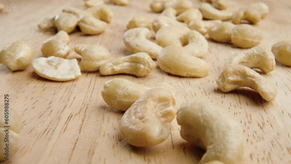 Close-up shot of scattering cashews on a wooden surface Close-up shot of scattering cashews on a wooden surface