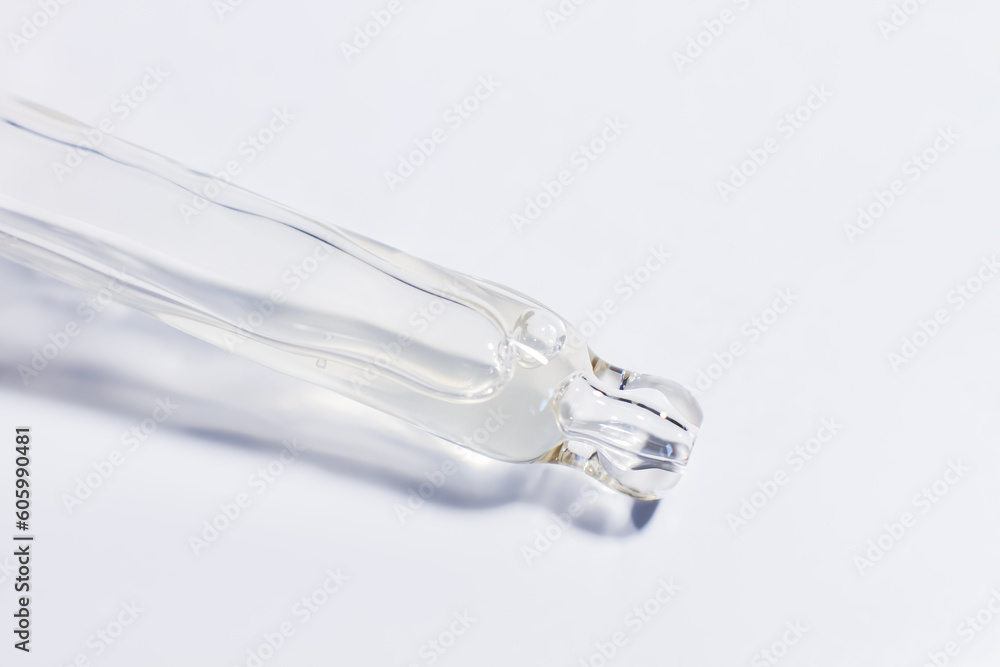 Transparent pipette with gel on a light background. Transparent pipette with gel on a light background.