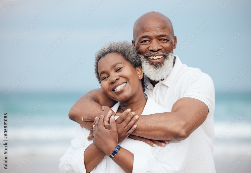 Fototapeta premium Hug, portrait and a senior couple at the beach for a vacation, retirement travel and walking. Smile, love and an elderly man and woman hugging with affection on a date by the ocean in Portugal