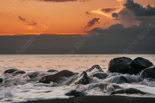 Beautiful view of ocean waves during sunset © Joshua Garcia1/Wirestock Creators
