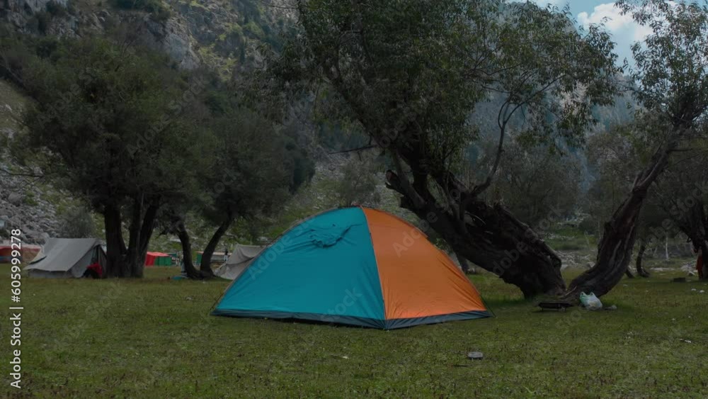 Drone shot of colorful camps in green mountains on a gloomy day, Shahi Bagh, Pakistan Drone shot of colorful camps in green mountains on a gloomy day, Shahi Bagh, Pakistan