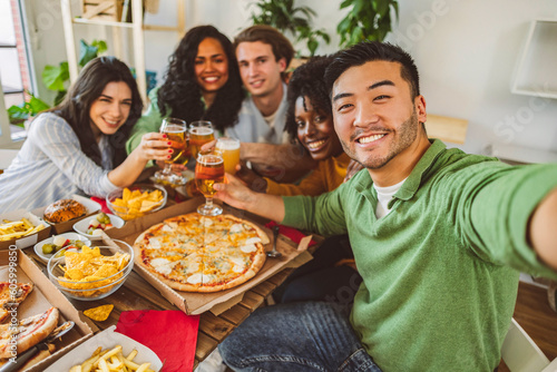 friends having pizza dinner at home selfie Lifestyle concept, multiracial group, focus on asian man