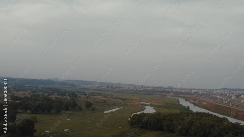 Aerial view of a river in between a green field near Islamabad, Pakistan Aerial view of a river in between a green field near Islamabad, Pakistan