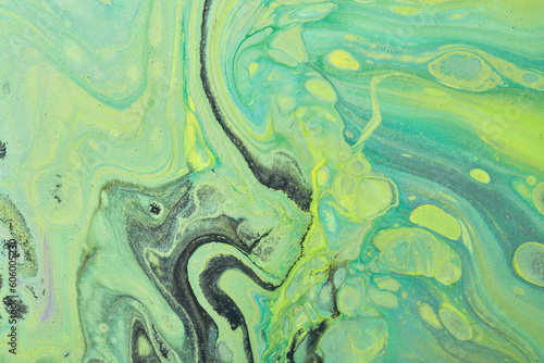 Abstract green color background. Multicolored fluid art. Waves, splashes and blots acrylic alcohol ink, paints under water