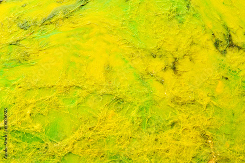 Multicolored creative abstract background. Texture of acrylic paint. Stains and blots of alcohol ink yellow colors, fluid art.