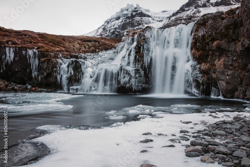 Scenic shot of icy waterfalls in Iceland during winter with a silky water effect