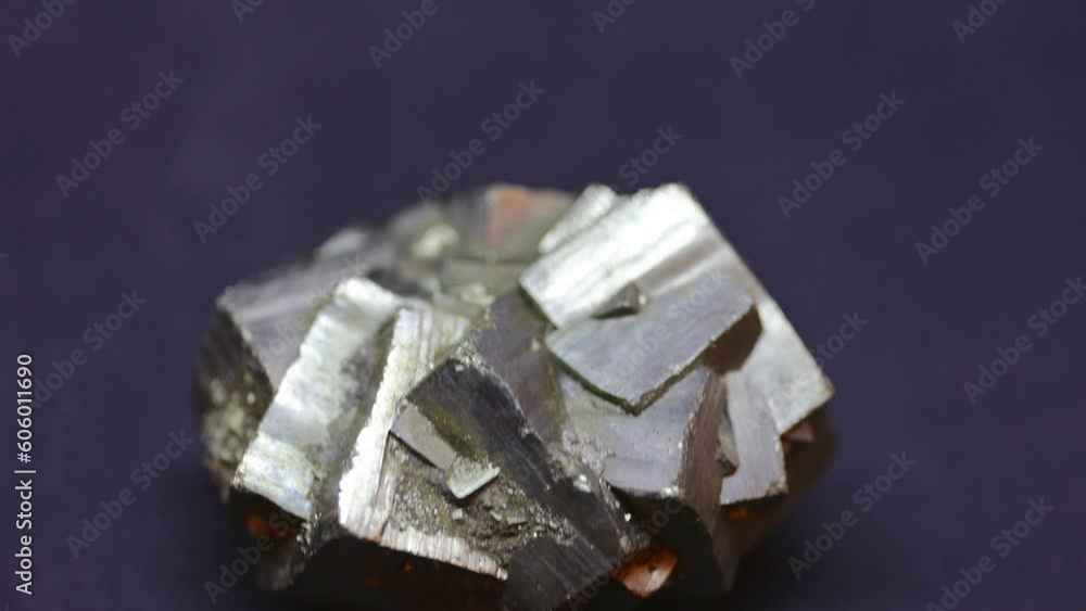Macro shot of Pyrite mineral from Madagascar on purple background Macro shot of Pyrite mineral from Madagascar on purple background