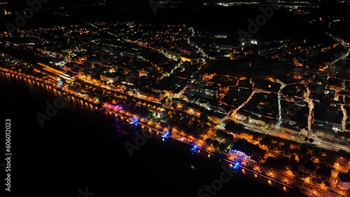 Aerial view of illuminated cityscape by the sea at night