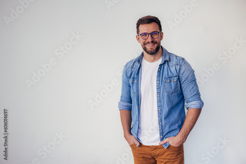 Isolated shot of young handsome man with beard, wearing casual clothes, posing in studio on white background © kerkezz