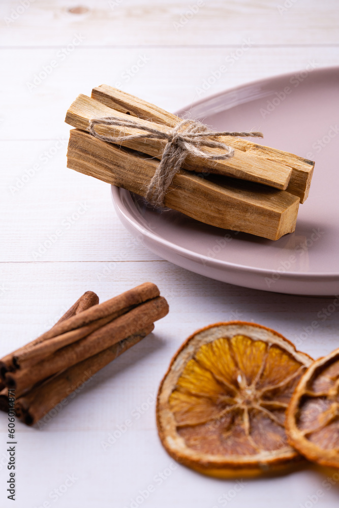 Natural incense for home scenting and meditation: palo santo sticks, cinnamon sticks and orange slices