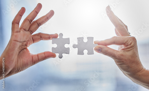 Puzzle, teamwork and partnership with hands of business people for synergy, support or trust. Integration, problem solving and solution with employees and jigsaw for mission, collaboration or process