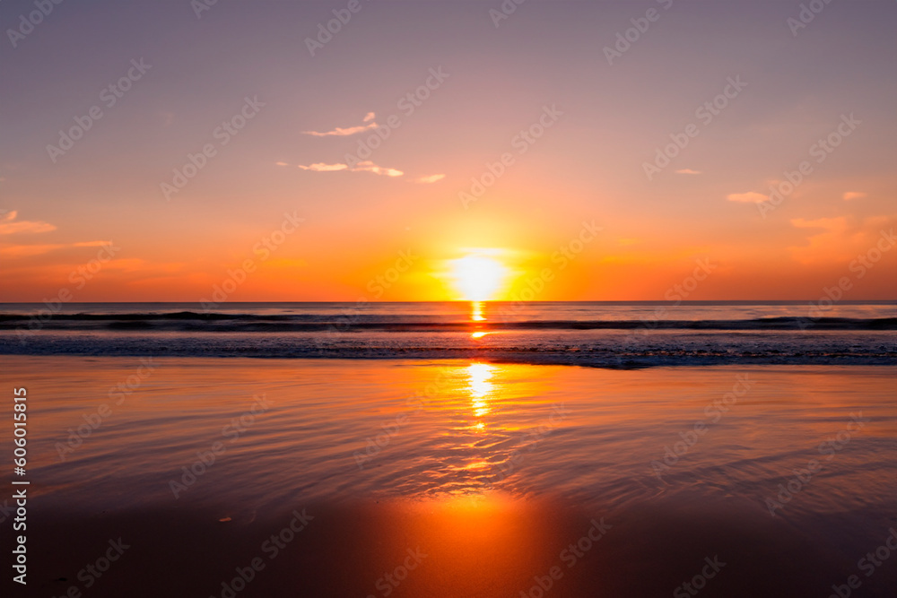 Sunset. Sunrise. Sunset on the shore of the beach with the sea calm and soft waves. Tranquility concept.