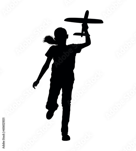 Girl holding and playing airplane toy silhouette.