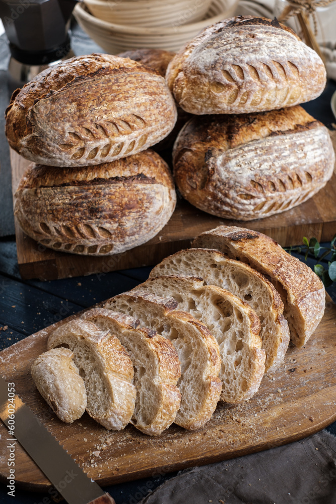 Artisan Batard Sourdough healthy Bread with leaf scoring. Open crumb high hydration Sourdough bread set on white table.