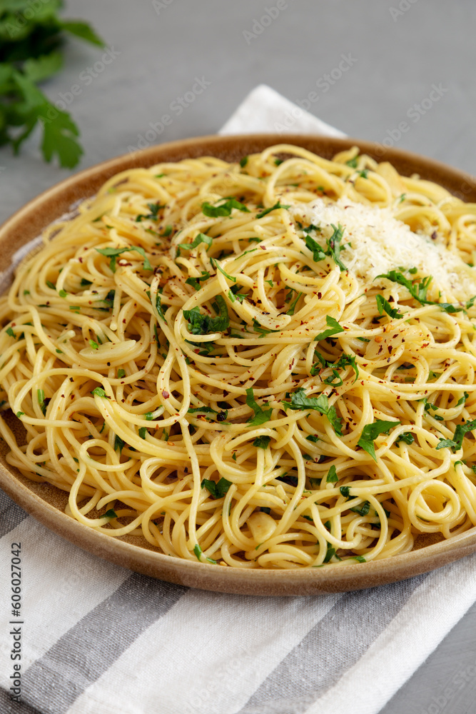 Homemade Italian Spaghetti Aglio e Olio on a Plate, side view. Homemade Italian Spaghetti Aglio e Olio on a Plate, side view.