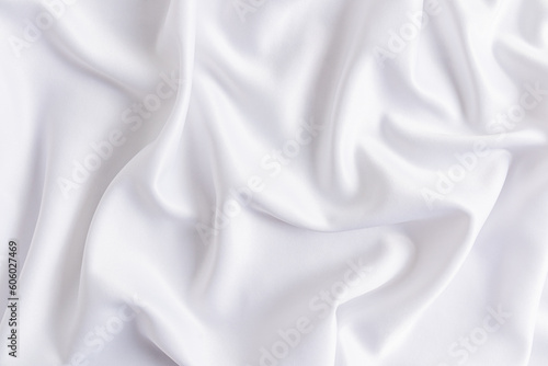 Delicate texture of white satin fabric with soft waves. Elegant white wedding background. layout for design.