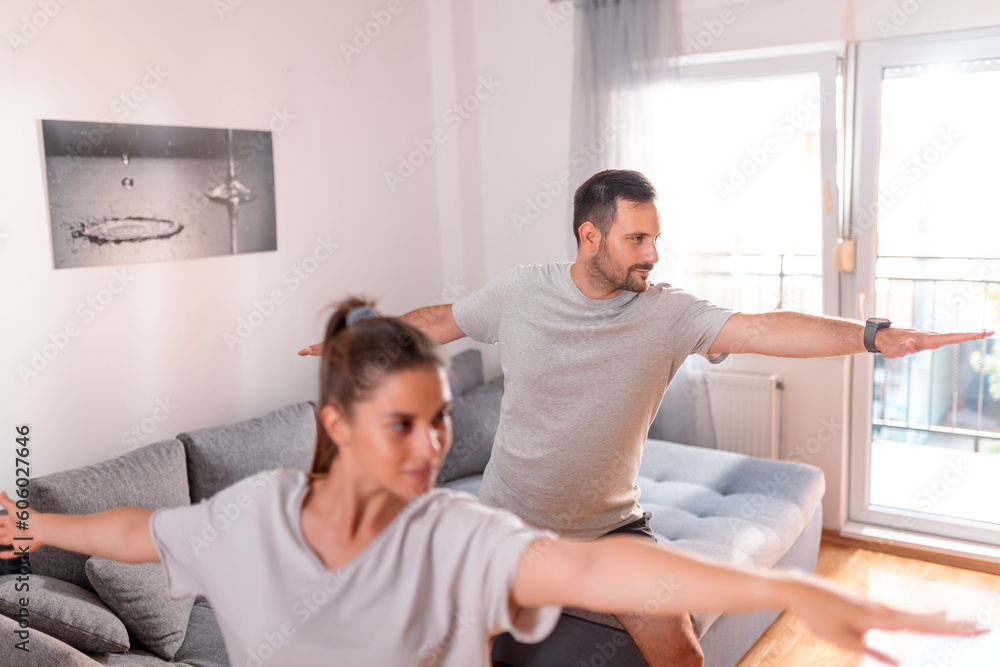 Couple doing yoga as morning exercise routine Couple doing yoga as morning exercise routine