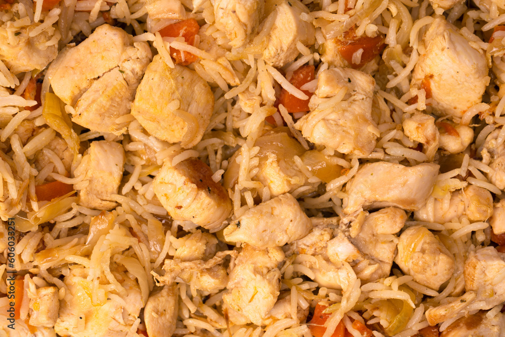 Tasty pilaf with chicken as background.