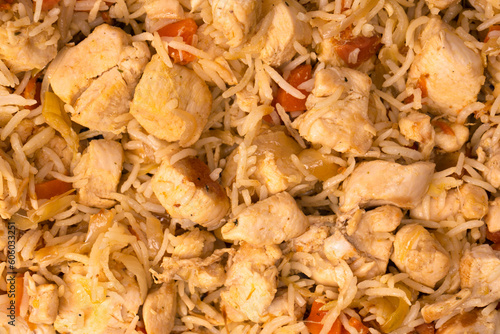 Tasty pilaf with chicken as background.