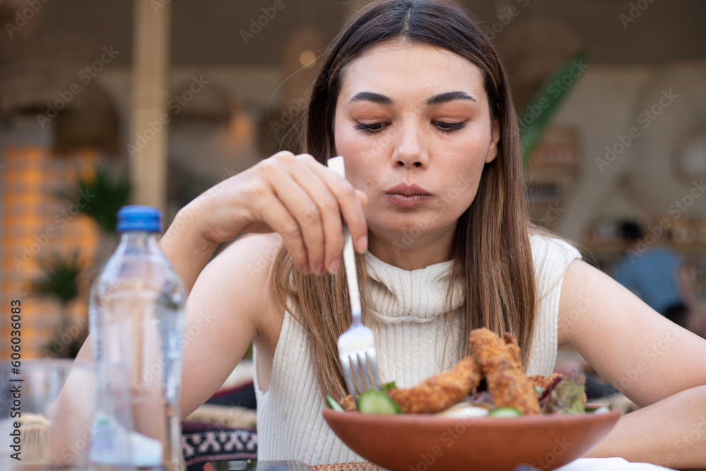 young woman eating food at cafe young woman eating food at cafe