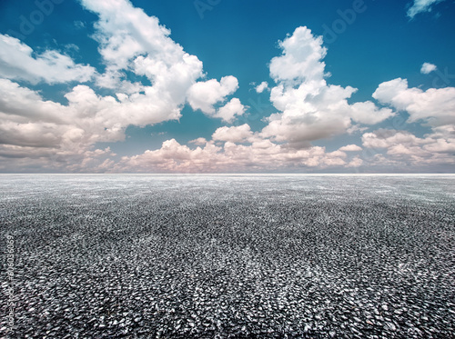 Unmanned asphalt pavement under the blue sky and white clouds © hqrloveq
