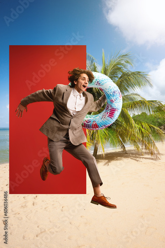 Obraz na płótnie Excited businessman in formalwear holding swimming circle and jumping into beach with palms