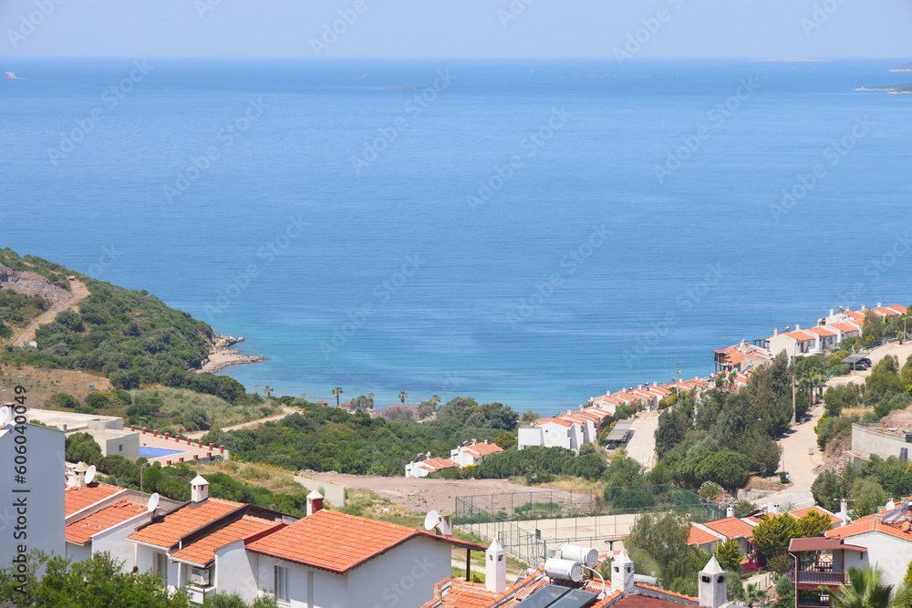 Fototapeta premium View of the highway, houses and mountains on the Aegean coast of Turkey, orange groves. Türkiye, May 2023.
