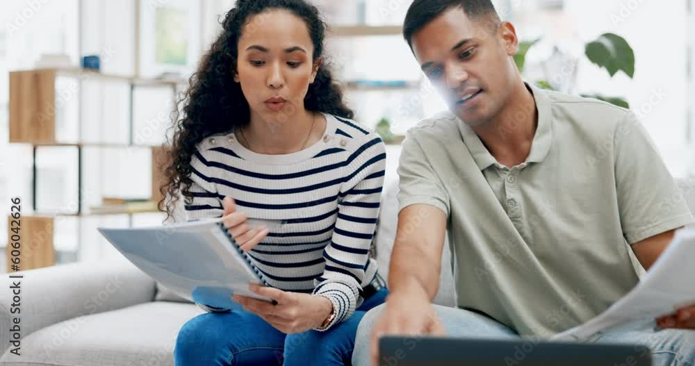 Couple, laptop and documents for finance, budget or planning expenses on living room sofa together at home. Man and woman working with paperwork on computer for financial plan, mortgage loan or bills Couple, laptop and documents for finance, budget or planning expenses on living room sofa together at home. Man and woman working with paperwork on computer for financial plan, mortgage loan or bills
